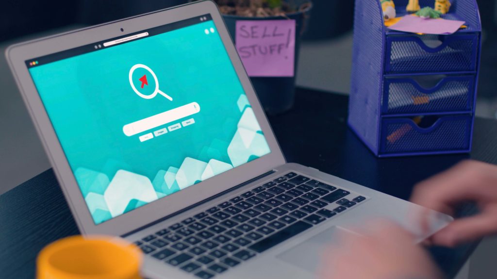 Hands typing at a laptop